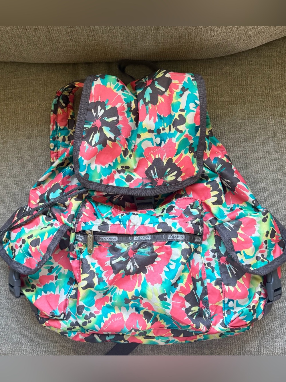 LeSportsac Voyager backpack features a vibrant multi-color floral print